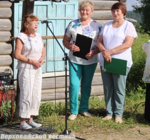 Староста Галина Александровна Шадрина прочитала на празднике свое стихотворение, посвященное Новой Деревне и ее жителям. Рядом – ведущие Александра Сабадош и Галина Бутусова